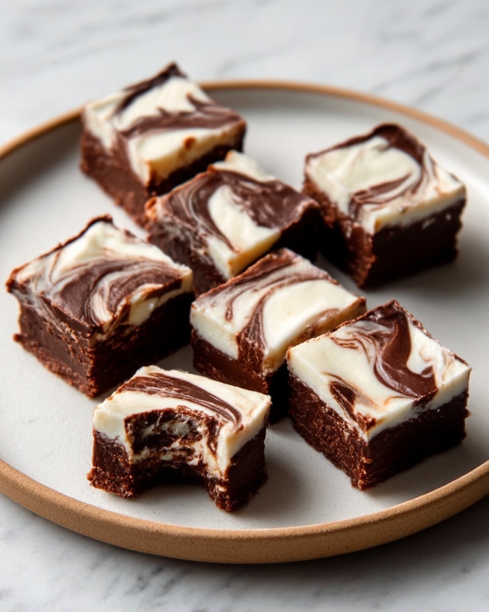 The image shows a gray plate with five pieces of layered chocolate fudge arranged on it. Each square piece has a dark brown chocolate base, topped with a thick white cream layer, then covered with a glossy dark chocolate layer that has a swirled pattern mixing the dark chocolate and white cream together. The swirls on the top layer create a smooth, marbled look. The plate sits on a white marbled surface. photo taken with an iphone --ar 4:5 --v 7